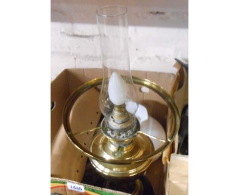 An antique oil lamp with black glazed base, glass chimney and opaque glass shade - converted to electric, for decorative use 