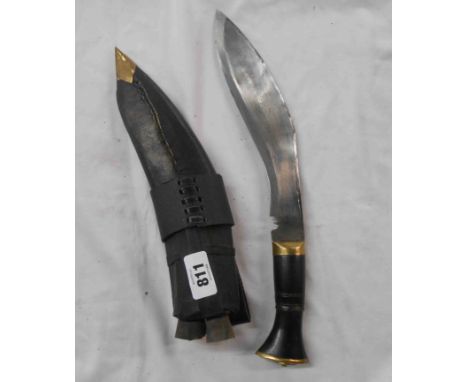 A vintage kukri in leather scabbard