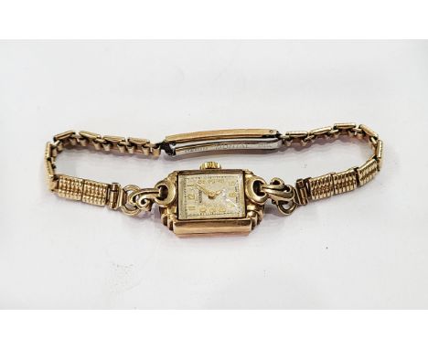 A vintage 375 (9ct.) gold cased Rotary lady's wristwatch with fifteen jewel movement, on rolled gold bracelet