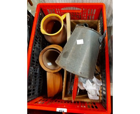 A red crate containing a box of tools, terracotta pot, etc.