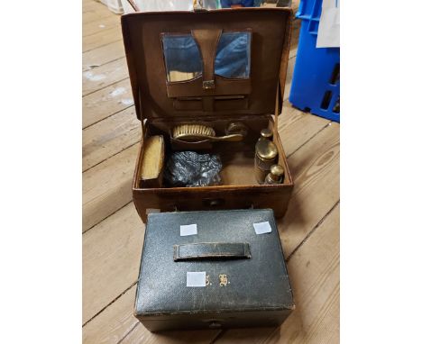 An old crocodile skin clad vanity case containing brass topped bottes, etc. - sold with a small green leather monogrammed jew