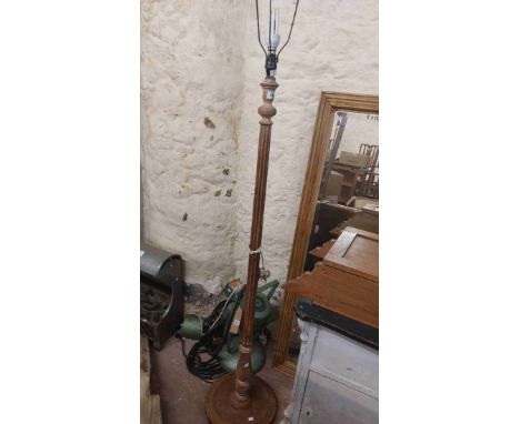 A vintage limed oak standard lamp with reeded pillar and circular base