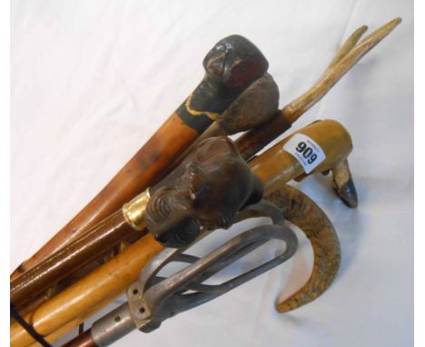 A bundle of walking sticks including parrot, pheasant and terrier headed examples, shooting stick, etc.