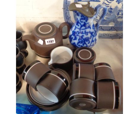 A vintage Hornsea pottery part tea set with white enamel decoration on a matt brown ground comprising teapot, milk jug, sucri