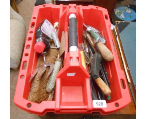 A plastic tool caddy containing a quantity of tools