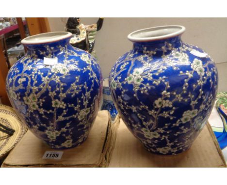 Two 20th Century Chinese porcelain vases with enamel prunus decoration on a blue ground - both in original cardboard boxes