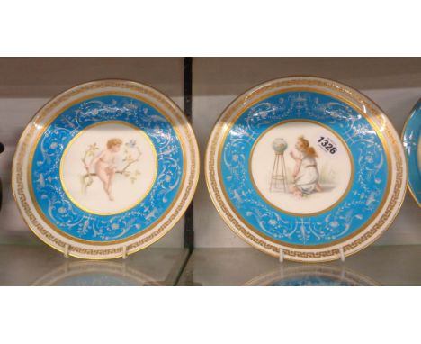 A pair of 19th Century Minton bone china cabinet plates, each decorated with a central hand painted panel depicting a girl wi