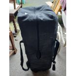 A Redkite folding travel cot in bag