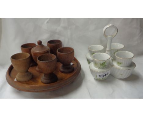 A 19th Century porcelain egg cup set comprising four egg cups, set in a stand, with transfer printed and hand painted floral 