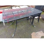 A black metal garden table and four chairs, all with mesh finish