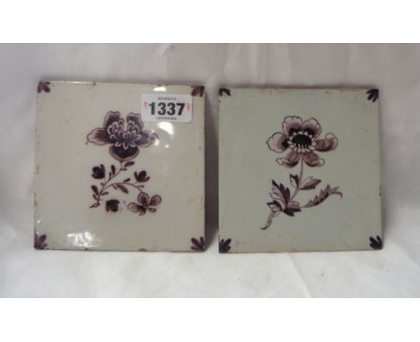 A pair of 18th Century English delftware tiles each decorated in manganise with a single flower