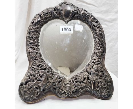 A 28.5cm high late Victorian silver fronted dressing table mirror with high relief embossed and pierced putti and scroll deco
