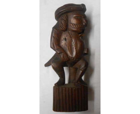 An antique carved wood nutcracker in the form of a seated gentleman (a/f)