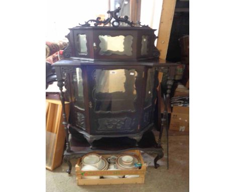 A 76cm late Victorian ornate ebonised vitrine cabinet with small canted and glazed compartment to top, a further larger mirro