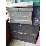 Three old wooden lift-top trunks - one containing a large model boat for restoration