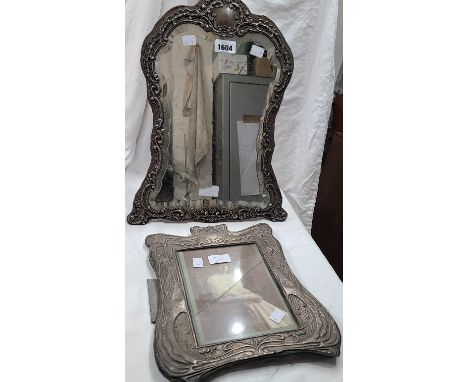A 44cm high Late Victorian silver fronted dressing table mirror with embossed Rococo scroll border and shaped bevelled plate,