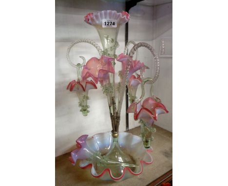 A late 19th Century cranberry and vaseline glass epergne, with large central flute on a wavy dish stand, three smaller flutes