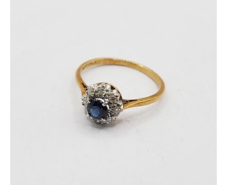 A vintage marked 18ct/PLAT ring, set with central circular small sapphire within a diamond encrusted border - size O 1/2 - bo