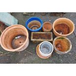 A quantity of terracotta garden pots including a blue glazed pot