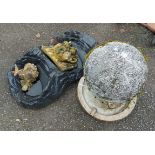 A group of small water features including one in the form of a goblin's head