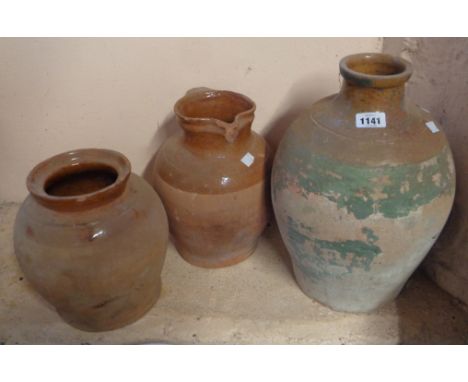 A large Verwood style country pottery jar with brown glazed shoulder and remains of painted finish - sold with a similar jug 