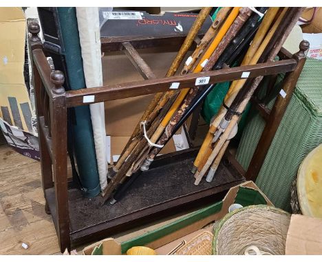 An early 20th Century stained wood stick stand with metal drip tray and flanking turned spindles