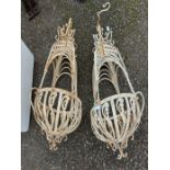 Two decorative hanging white metal basket form planters