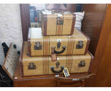 A matching part set of vintage American luggage comprising vanity case and two graduated suitcases with leather binding and s