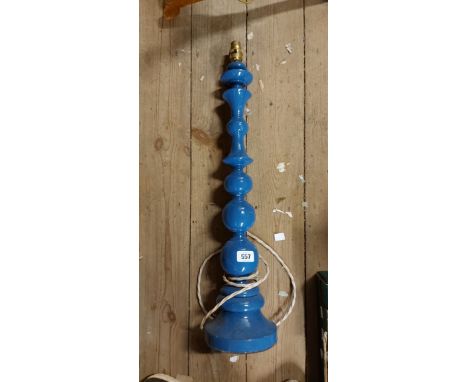 A tall painted blue wooden lamp base