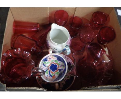 A box containing a quantity of Victorian and later Cranberry glassware including jugs, drinking glasses, etc. - sold with two