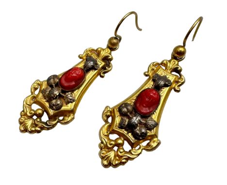A pair of Victorian yellow metal drop earrings set with carved coral cameos depicting a lady and a gentleman, 3.9g, 4cm drop