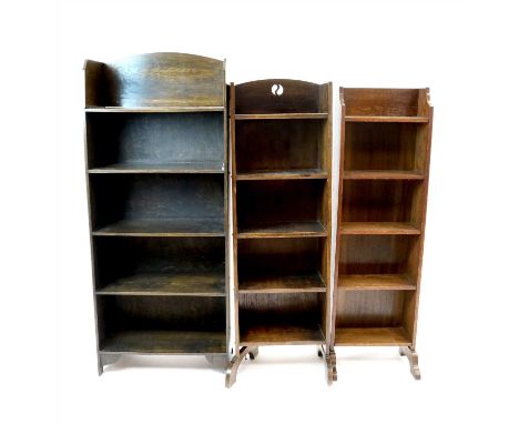 Three free-standing early 20th century oak bookcases to include an example with pierced back and studded sides accommodating 