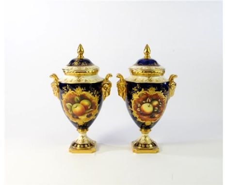 A pair of Coalport vases and covers late 20th century each painted with an oval panel of fruit, signed B. Higham, against an 