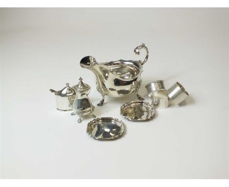 A silver sauce boat, Walker &amp; Hall, Sheffield 1900, weight approx 8.7oz, together with four silver napkin rings, a pair o