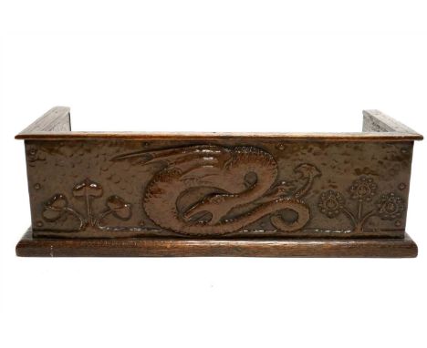An English school copper clad oak Arts and Crafts book trough, the panels with repoussé decoration, the front panel detailing