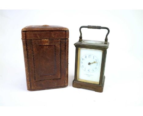 An Edwardian brass cased and further boxed brass framed carriage clock, the white dial painted with Arabic numerals, marked G