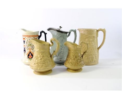 A collection of 19th century jugs including a buff caneware jug relief decorated with a battle scene of soldiers and a war el