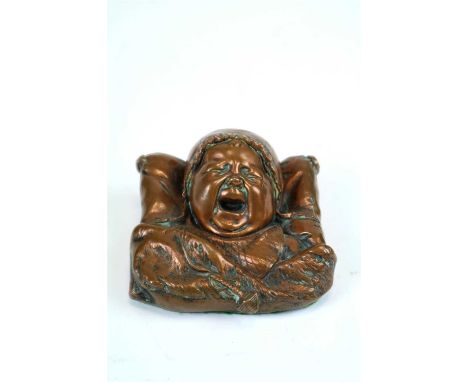 An early 20th century cast copper paperweight in the form of a bust-length portrait of a crying infant, signed to side ‘Aigon