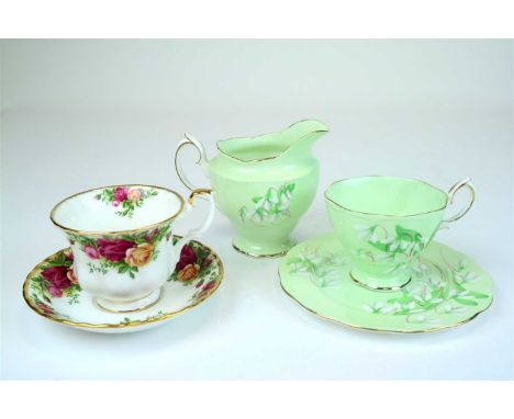 A Royal Albert tea service in the Laurentian Snowdrop pattern comprising six teacups, six saucers, six sideplates, milk jug, 