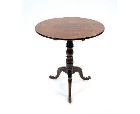 A Victorian mahogany snap top tripod table, the circular top on a turned column support raised on three swept cabriole legs