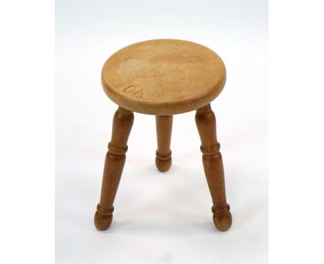 A small turned wooden carved stool, the circular top with fluted border and inscribed with the name ‘David’, raised on three 