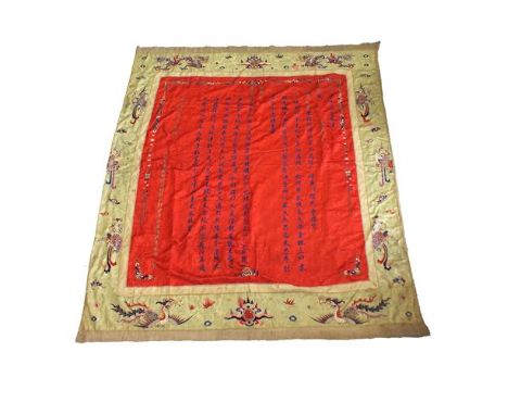 A large Chinese red silk wall hanging, Autumn, 1912, in blue and gold embroidered vertical script of various sizes, wide gold