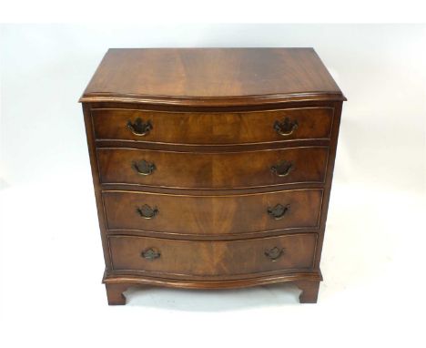 A mahogany veneered serpentine chest of four graduating long drawers, in well matched flamed veneers, the cockbeaded drawers 