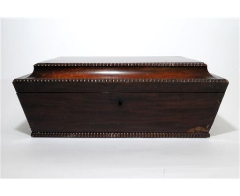 A Regency mahogany sarcophagus shape caddy box, the rectangular gadrooned top with concave border and enclosing a vacant cent