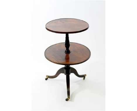 A Regency mahogany and simulated rosewood two tier dumb waiter, early 19 th century, the two revolving tiers each with reeded