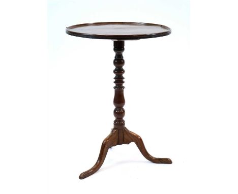 A George III oak tray top tripod table, the circular top with a raised border above a turned column stem raised on swept supp