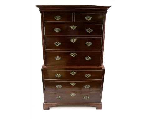 A George III mahogany chest on chest, the top fitted with two short and three graduating long drawers, within fluted canted c