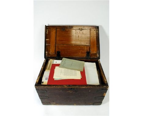 An old stained pine chest with hinged lid and reinforced corners containing an interesting collection of ephemera relating to