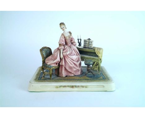 A Capodimonte porcelain figure of a female pianist circa 1970s-80s the female dressed in a pale pink dress and modelled stand