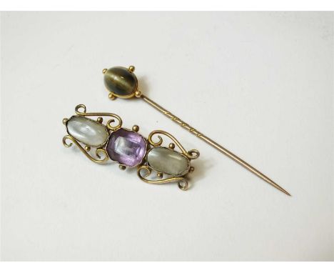 A cats eye chrysoberyl stick pin, together with a three stone amethyst and moonstone bar brooch (2)